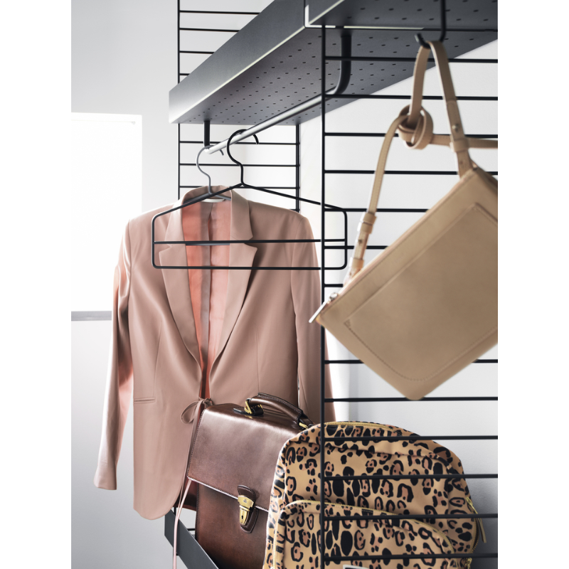 The J Hook from String Furniture holding clothing and bags.