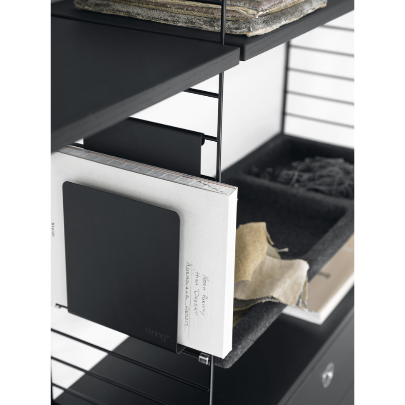 The Magazine Holder from String Furniture in a family space lifestyle photograph.