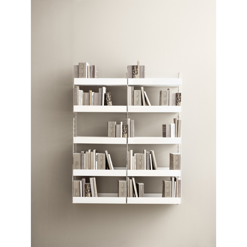 The Metal Shelves High from String Furniture being used as a bookshelf.
