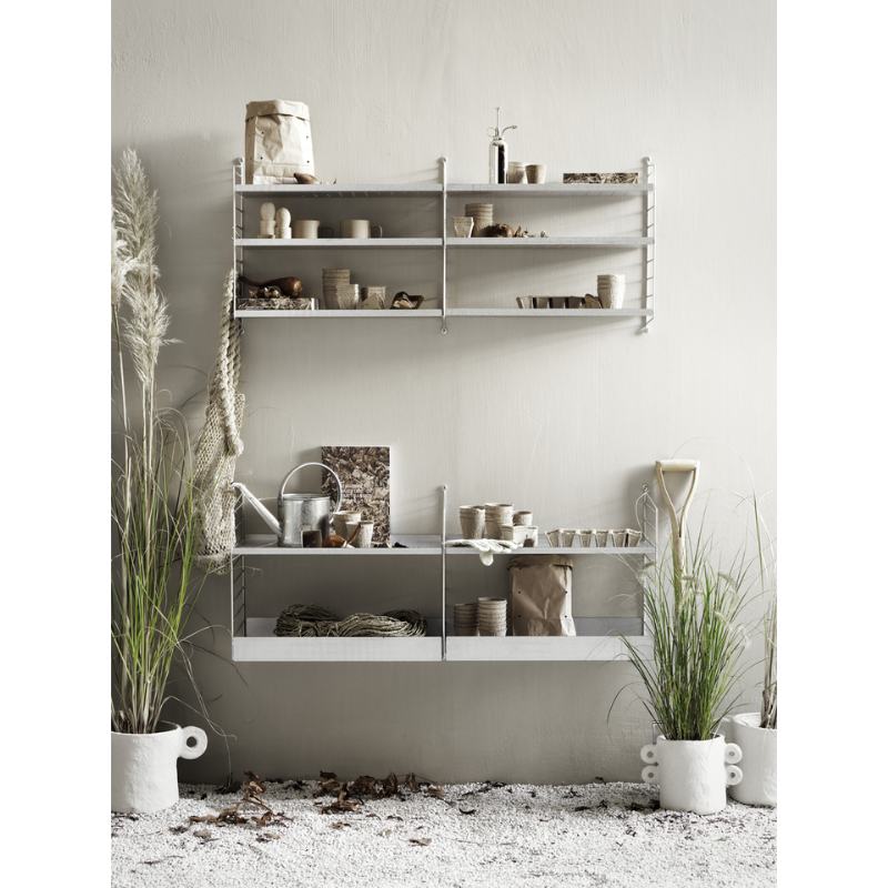 The Shelves Galvanized from String Furniture among various plants and gardening tools.