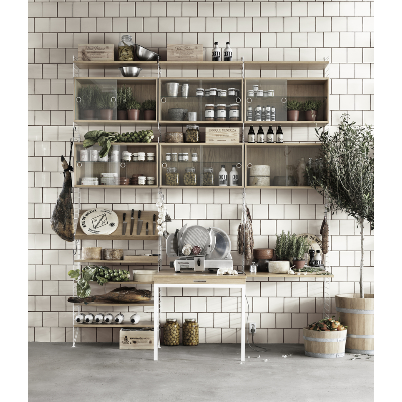 The Shelves from String Furniture in a kitchen and dining set up.