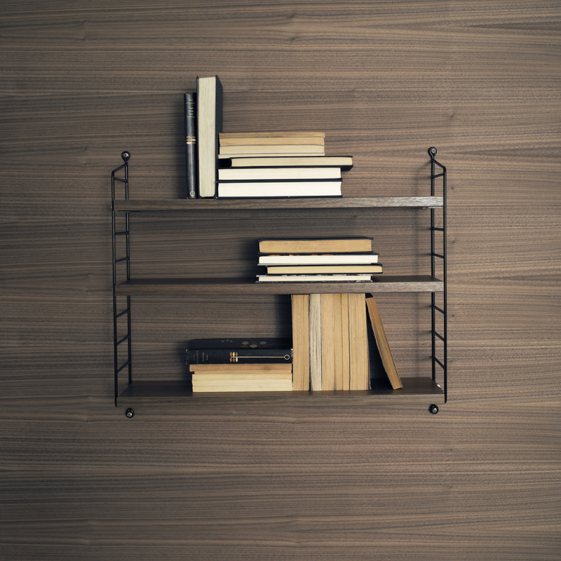 The String Pocket from String Furniture used as a bookshelf.