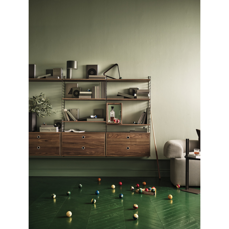 The Tiny Cabinet from String Furniture in a family space.