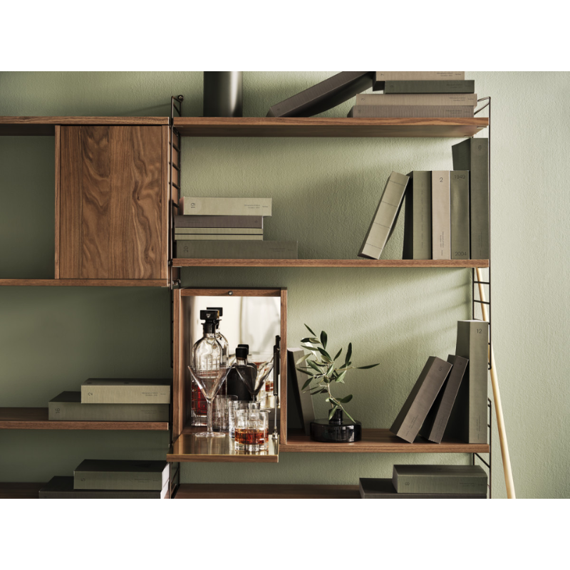 The Tiny Cabinet from String Furniture in a lounge.