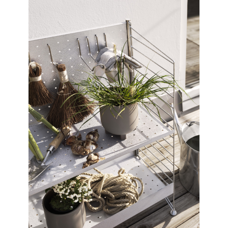 The Vertical Double Hook from String Furniture in an outdoor living space.