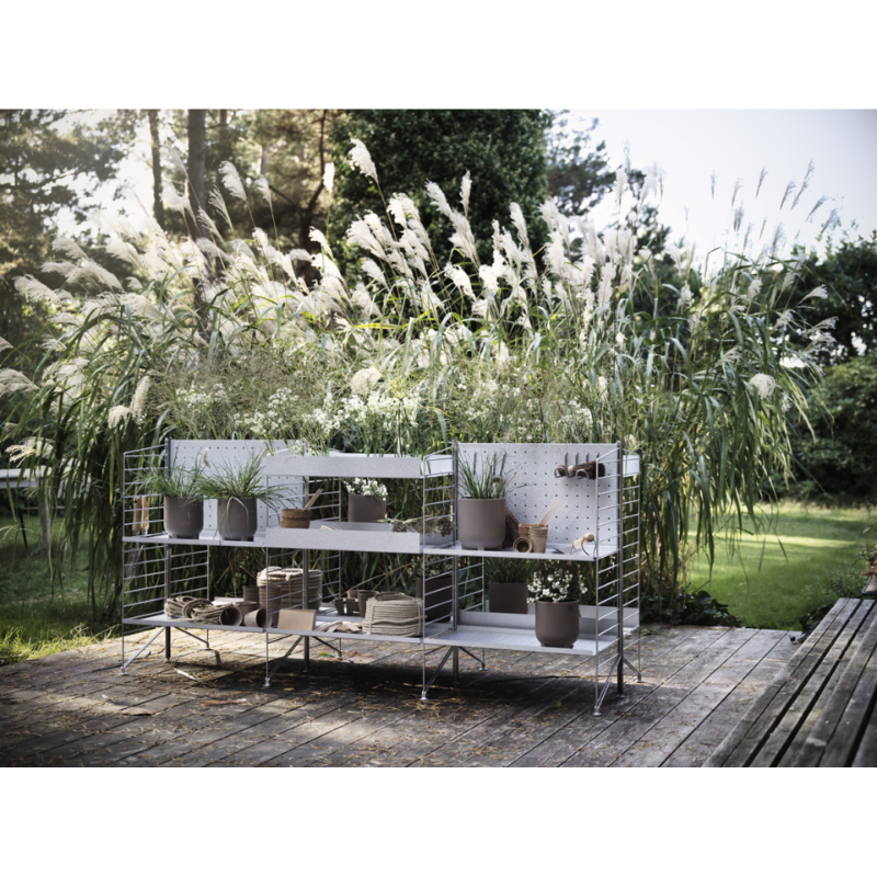 The Vertical Hook from String Furniture outdoors in a lounge.