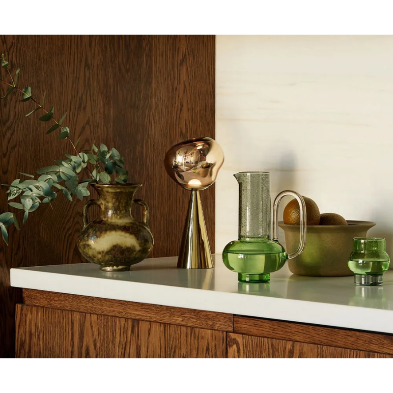 The Bump Jug in green by Tom Dixon with a Bump Short Glass and Portable Melt LED.