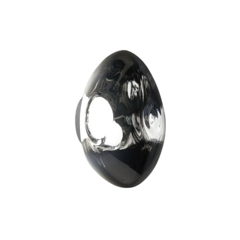 Tom Dixon's Melt LED Surface Wall Sconce is a beautifully distorted pendant in collection of modern finishes with matching ceiling rose. Featuring an integrated LED module, this ceiling light creates a mesmerizing melting hot-blown glass effect when turned on, and a mirror-finish effect when off. This piece is made in Germany using a high tech manufacturing techniques to achieve the perfect melted orb for your design.