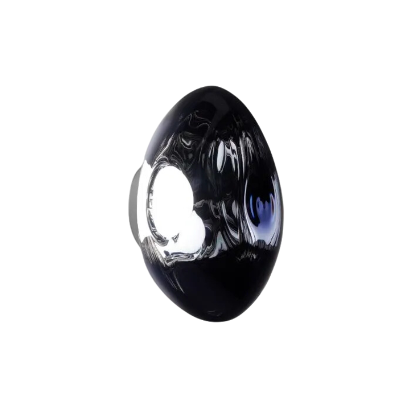 Tom Dixon's Melt LED Surface Wall Sconce is a beautifully distorted pendant in collection of modern finishes with matching ceiling rose. Featuring an integrated LED module, this ceiling light creates a mesmerizing melting hot-blown glass effect when turned on, and a mirror-finish effect when off. This piece is made in Germany using a high tech manufacturing techniques to achieve the perfect melted orb for your design.