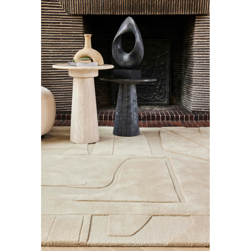The Collage Wool Rug from Toulemonde Bochart in a family space near a fireplace.