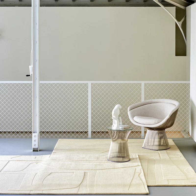The Collage Wool Rug from Toulemonde Bochart in an open space area.