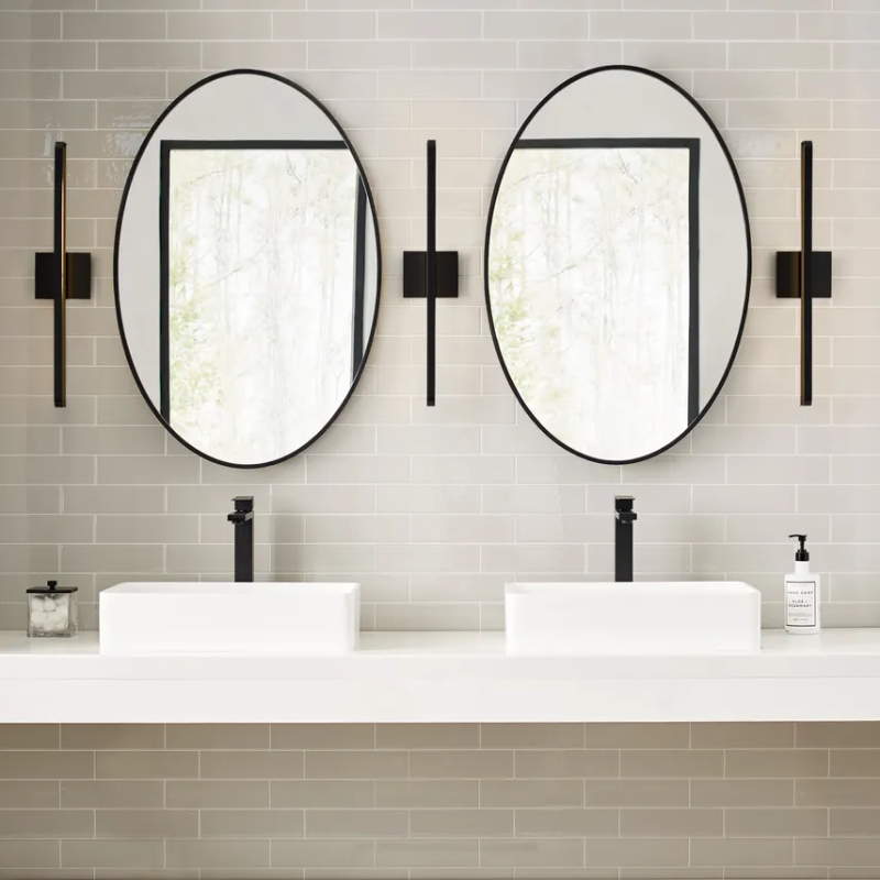 The Banda Bathroom Sconce from Visual Comfort & Co. in a jack and jill bathroom.