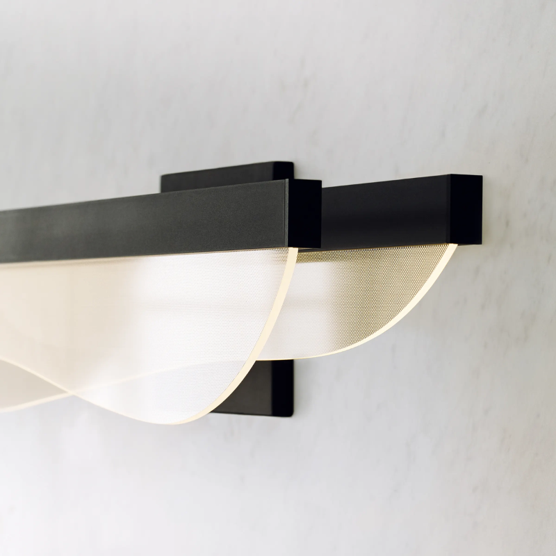 The Nyra Bathroom Sconce from Visual Comfort and Co focusing on the LED light.