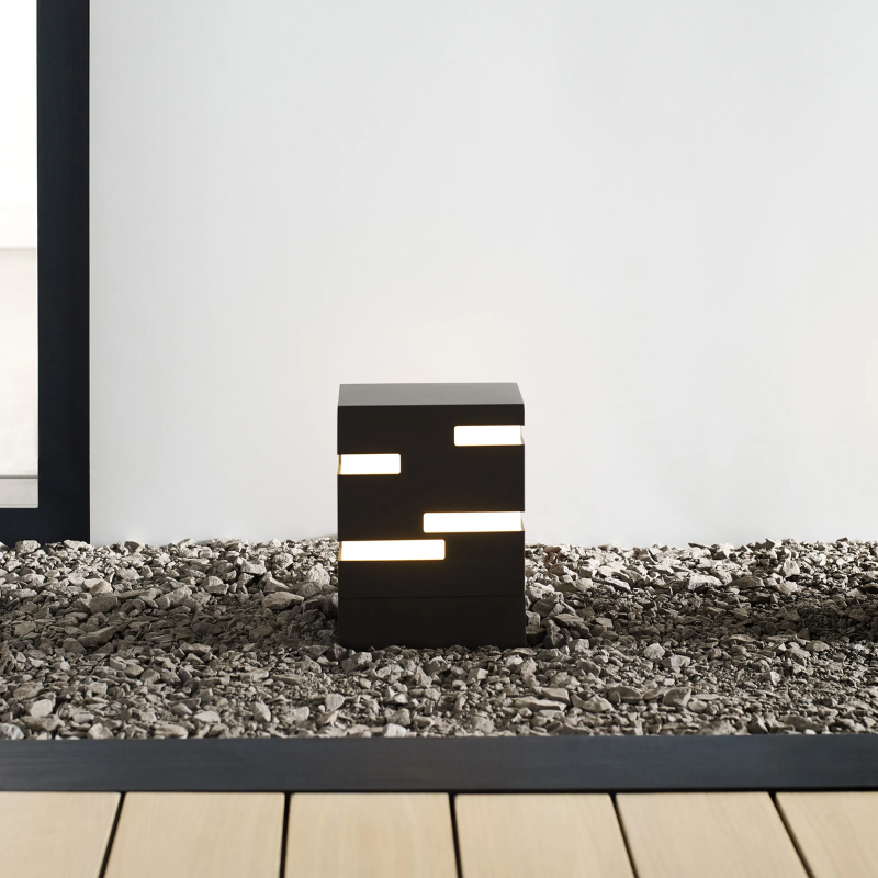 The Revel Outdoor Bollard from Visual Comfort and Co. in an outdoor lounge.