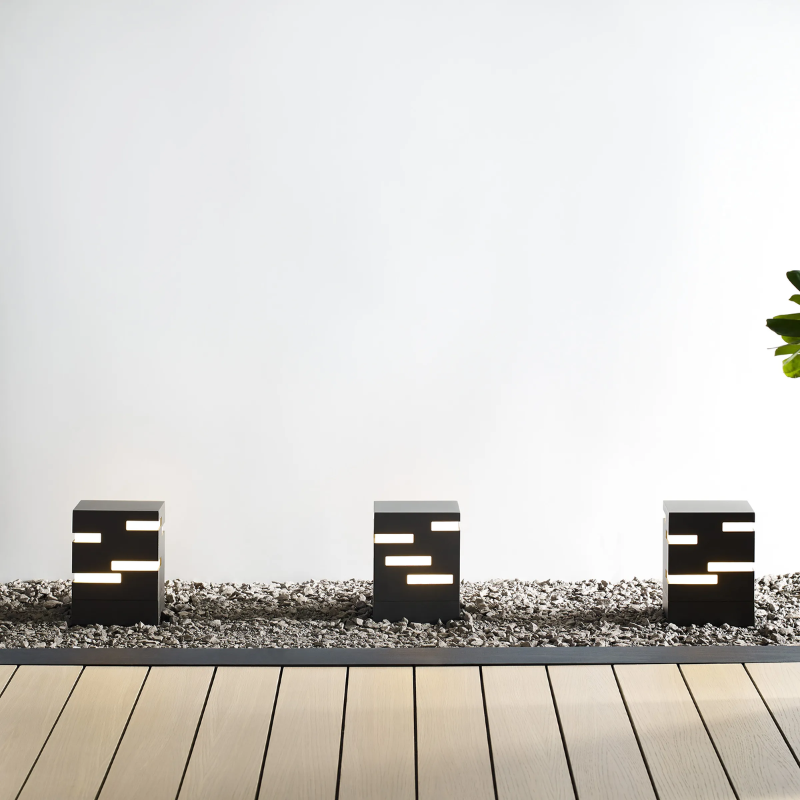 The Revel Outdoor Bollard from Visual Comfort and Co. illuminating an outdoor pathway.