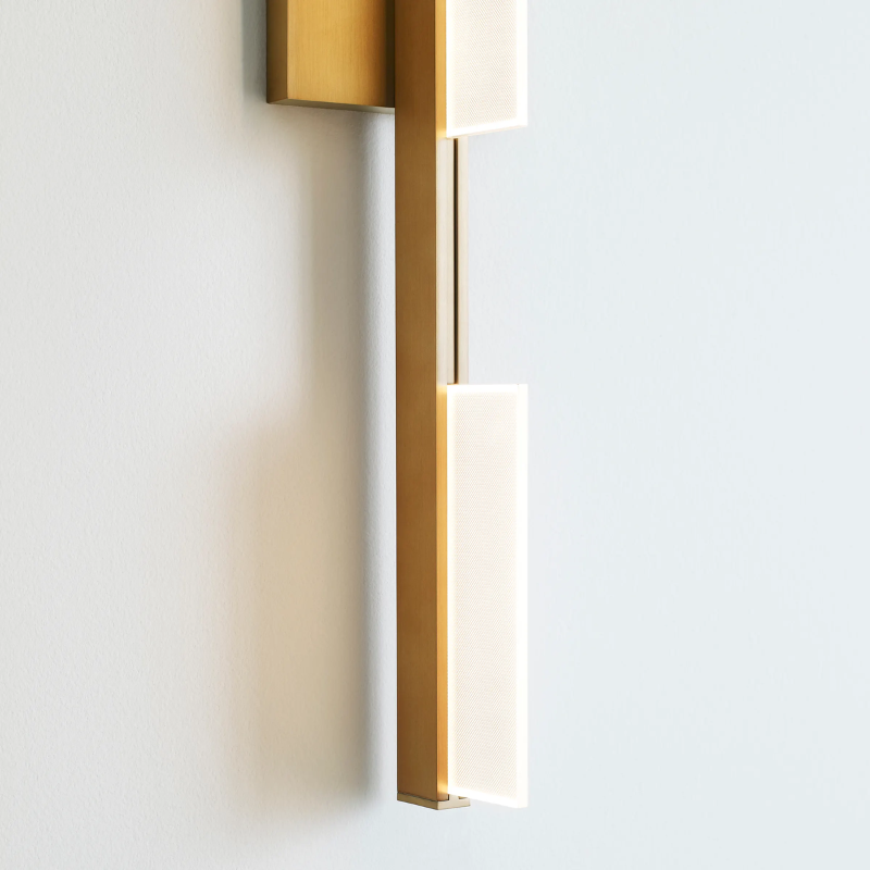 The Tris 3-Light Bathroom Sconce from Visual Comfort and Co in a close up shot.