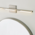 The Tris 3-Light Bathroom Sconce from Visual Comfort and Co in a home lifestyle photograph.