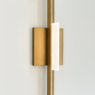 The Tris 3-Light Bathroom Sconce from Visual Comfort and Co in a photograph focusing on the LED light.