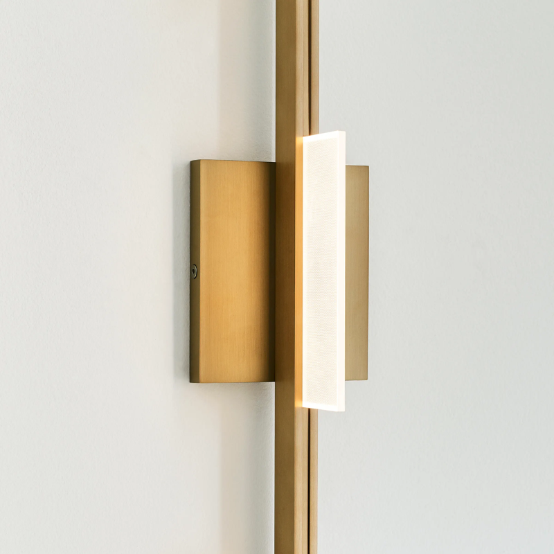 The Tris 3-Light Bathroom Sconce from Visual Comfort and Co in a photograph focusing on the LED light.