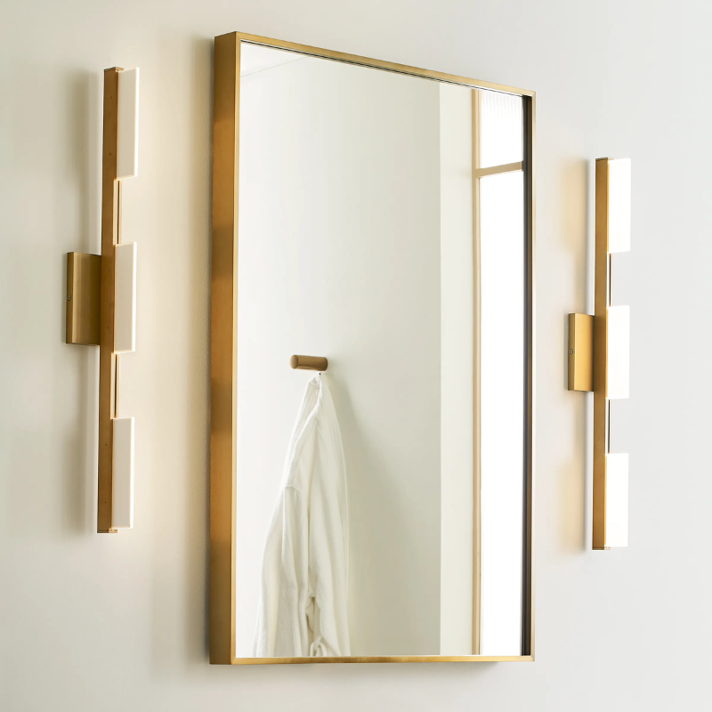 The Tris 3-Light Bathroom Sconce from Visual Comfort and Co illuminating a mirror either side.