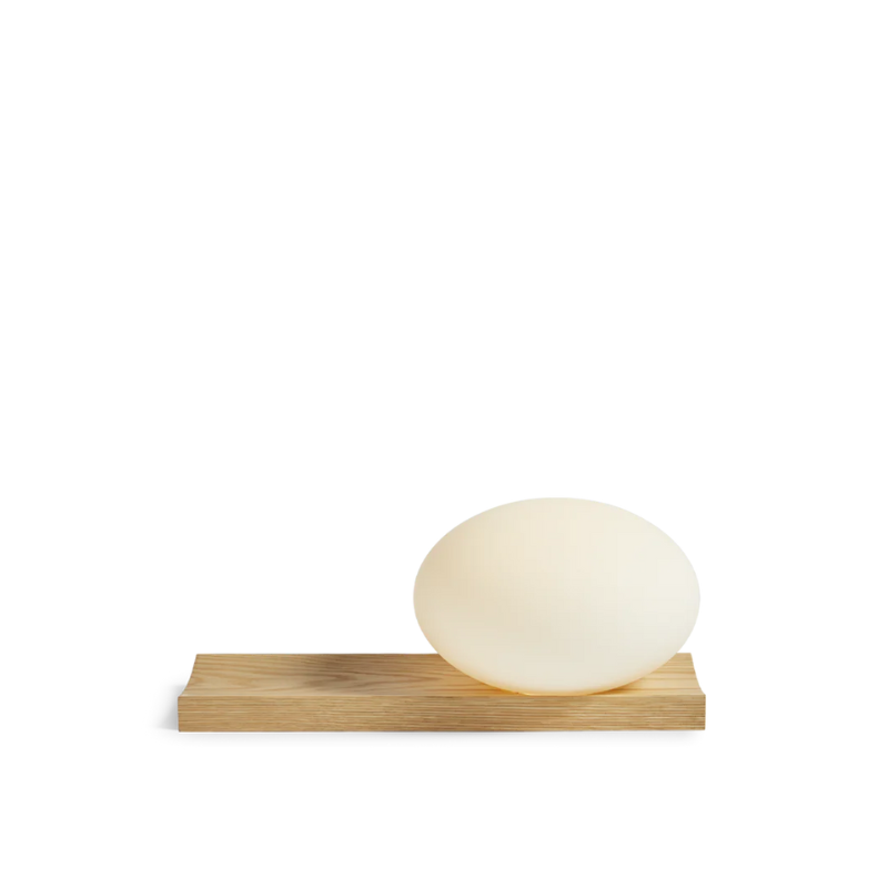 With its portable character, the versatile piece functions as a dynamic table and wall lamp. At the same time, its dimmable feature allows you to change the mood and intensity of the light to suit the specific setting. Place it on a desk, use the tray for your pieces of jewelry or hang it on the wall to provide an inviting light with no need for an electrical supply.