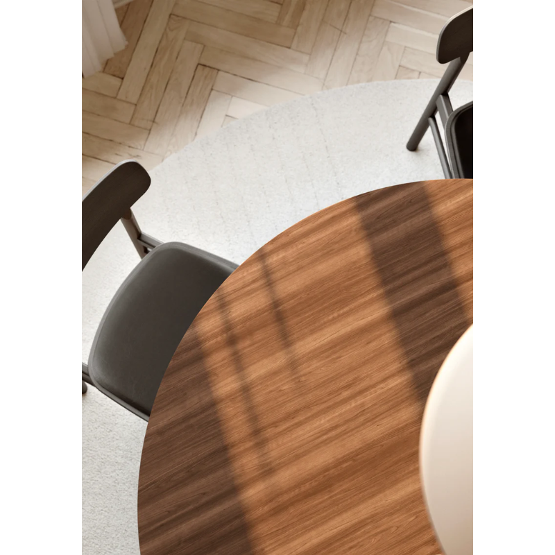 A close up on the Walnut Ludo Dining Table from Woud.