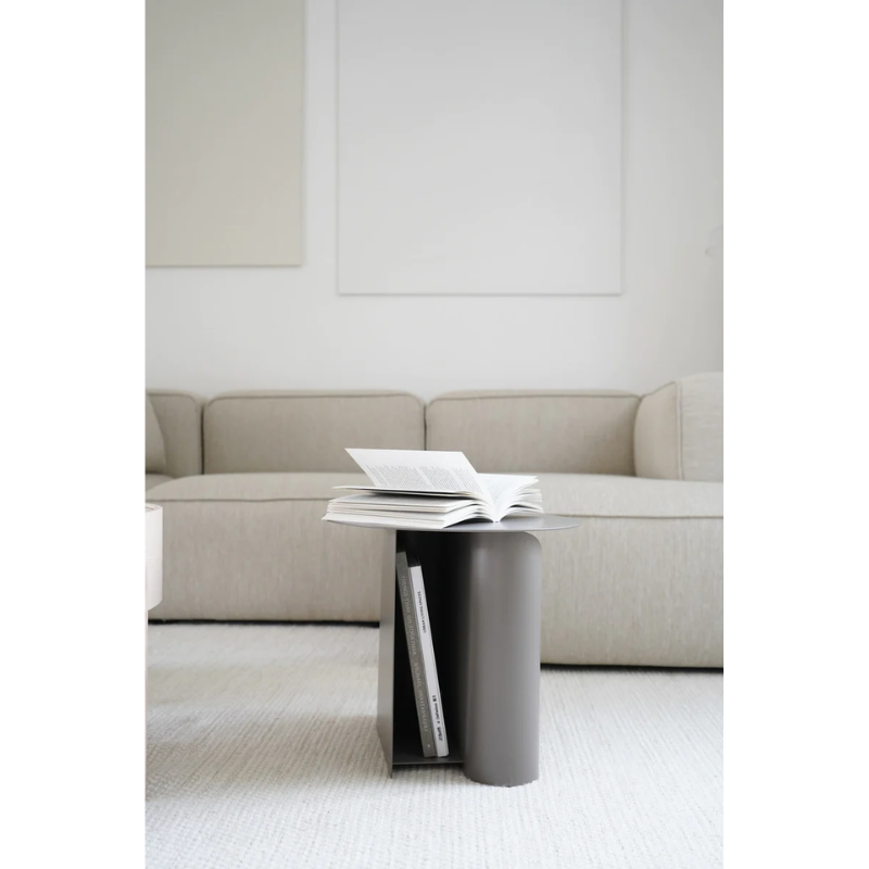 The Sentrum side table follows the principle of simplicity as it has been stripped from all unnecessary elements. What is left is a strong base and geometrical expression with pure functionalities. The S-shaped construction makes the center of attention and creates two spaces for storage on both sides to enhance the usability of the side table - ideal for magazines and books.