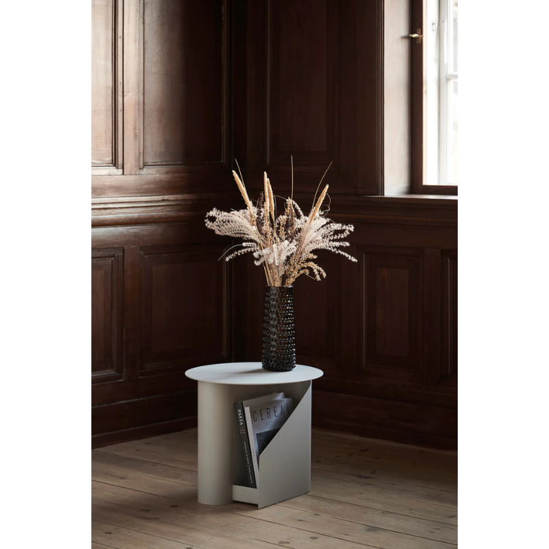 The Sentrum side table follows the principle of simplicity as it has been stripped from all unnecessary elements. What is left is a strong base and geometrical expression with pure functionalities. The S-shaped construction makes the center of attention and creates two spaces for storage on both sides to enhance the usability of the side table - ideal for magazines and books.