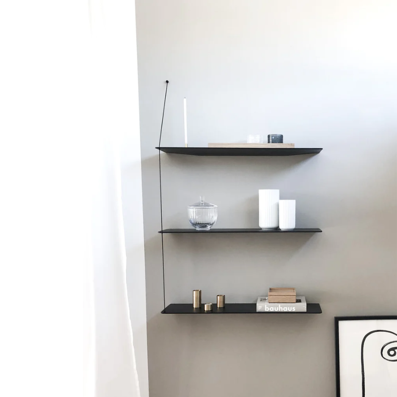 Stedge is all about lightness, purism and a clear structure. The subtle design is an optical illusion as the solid shelves seem to hang by a thread. With its light expression and fine edges, Stedge will be a perfect match for any room. Extend the shelving system with more shelves and choose either a long or short top wire to make it a perfect fit on your wall. Available in two widths.