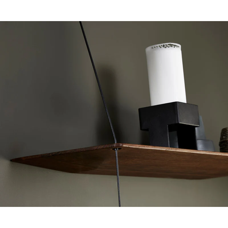 Stedge is all about lightness, purism and a clear structure. The subtle design is an optical illusion as the solid shelves seem to hang by a thread. With its light expression and fine edges, Stedge will be a perfect match for any room. Extend the shelving system with more shelves and choose either a long or short top wire to make it a perfect fit on your wall. Available in two widths.