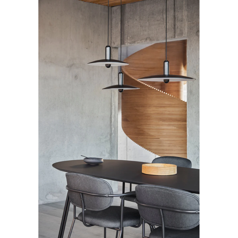 The beige and black large Tree Dining Table from Woud in a modern dining setup in a close up.