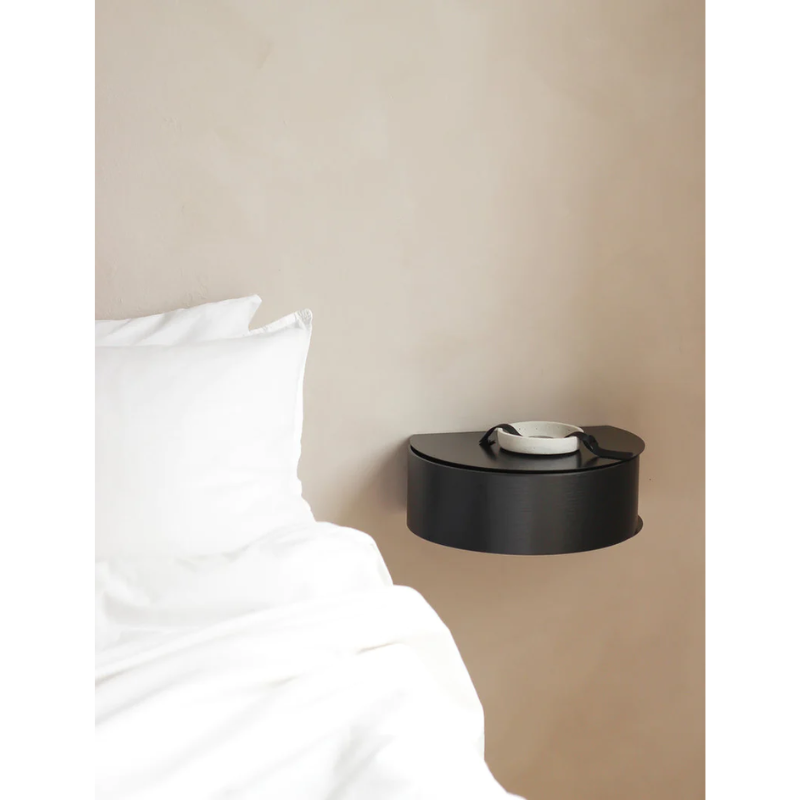 Wallie beautifully combines bent walnut with solid black metal creating an elegant wall-mounted drawer. With its circular, soft shapes Wallie is a visually strong design that easily can act as a centerpiece or be combined with other designs. The bracket embraces the magnetic wood drawer making the design both minimalistic and functional. Wallie is perfect for storing small everyday essentials in the hallway or as a bedside table in the bedroom.
