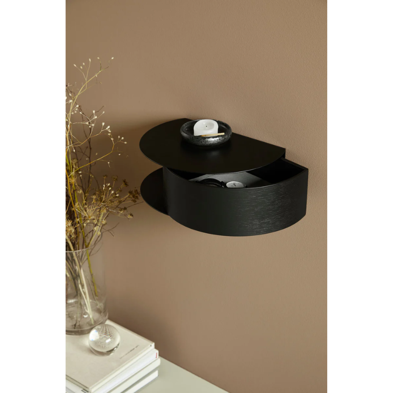 Wallie beautifully combines bent walnut with solid black metal creating an elegant wall-mounted drawer. With its circular, soft shapes Wallie is a visually strong design that easily can act as a centerpiece or be combined with other designs. The bracket embraces the magnetic wood drawer making the design both minimalistic and functional. Wallie is perfect for storing small everyday essentials in the hallway or as a bedside table in the bedroom.