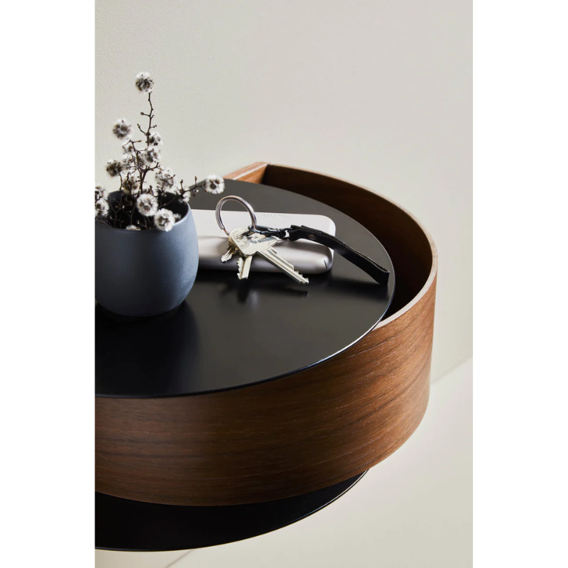 Wallie beautifully combines bent walnut with solid black metal creating an elegant wall-mounted drawer. With its circular, soft shapes Wallie is a visually strong design that easily can act as a centerpiece or be combined with other designs. The bracket embraces the magnetic wood drawer making the design both minimalistic and functional. Wallie is perfect for storing small everyday essentials in the hallway or as a bedside table in the bedroom.