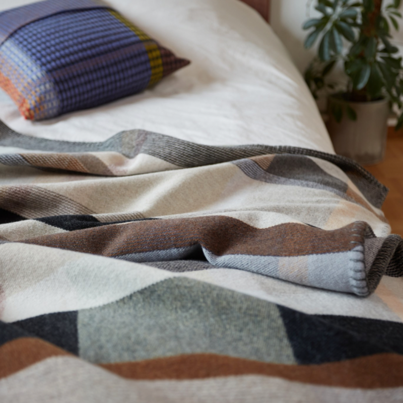 The Chipperfield Throw from the Wallace & Sewell Block Throw Collection is inspired by Korean artist, Chung Eun Mo's abstract paintings. This stunning throw features a bold checkerboard pattern of juxtaposed blocks and striking hues. Made from sumptuous merino lambswool and finished with blanket stitches for added elegance, the Chipperfield Throw is reversible with a different colorway on each side.