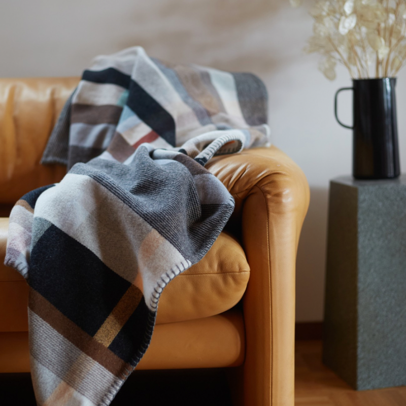 The Chipperfield Throw from the Wallace & Sewell Block Throw Collection is inspired by Korean artist, Chung Eun Mo's abstract paintings. This stunning throw features a bold checkerboard pattern of juxtaposed blocks and striking hues. Made from sumptuous merino lambswool and finished with blanket stitches for added elegance, the Chipperfield Throw is reversible with a different colorway on each side.