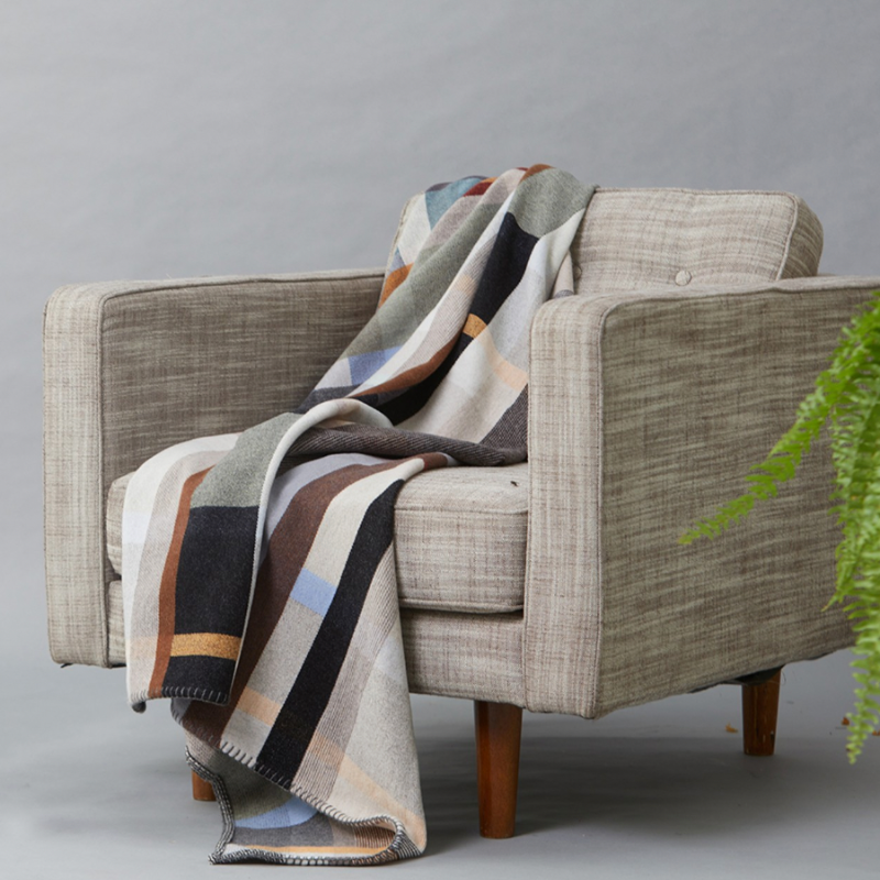 The Chipperfield Throw from the Wallace & Sewell Block Throw Collection is inspired by Korean artist, Chung Eun Mo's abstract paintings. This stunning throw features a bold checkerboard pattern of juxtaposed blocks and striking hues. Made from sumptuous merino lambswool and finished with blanket stitches for added elegance, the Chipperfield Throw is reversible with a different colorway on each side.