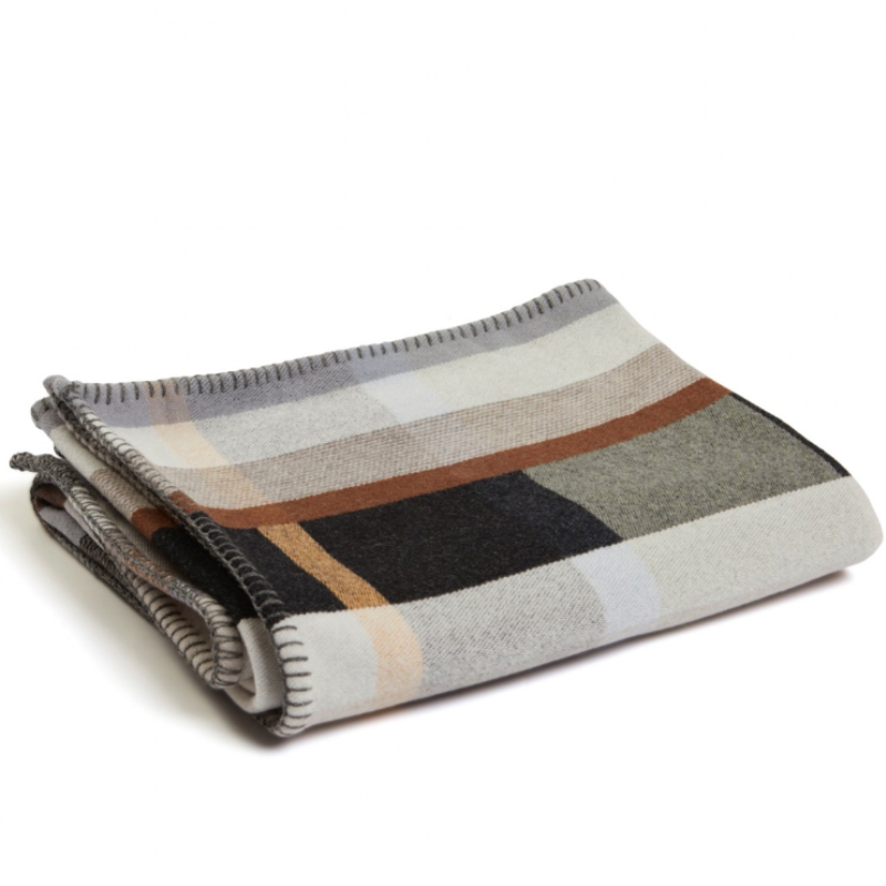 The Chipperfield Throw from the Wallace & Sewell Block Throw Collection is inspired by Korean artist, Chung Eun Mo's abstract paintings. This stunning throw features a bold checkerboard pattern of juxtaposed blocks and striking hues. Made from sumptuous merino lambswool and finished with blanket stitches for added elegance, the Chipperfield Throw is reversible with a different colorway on each side.