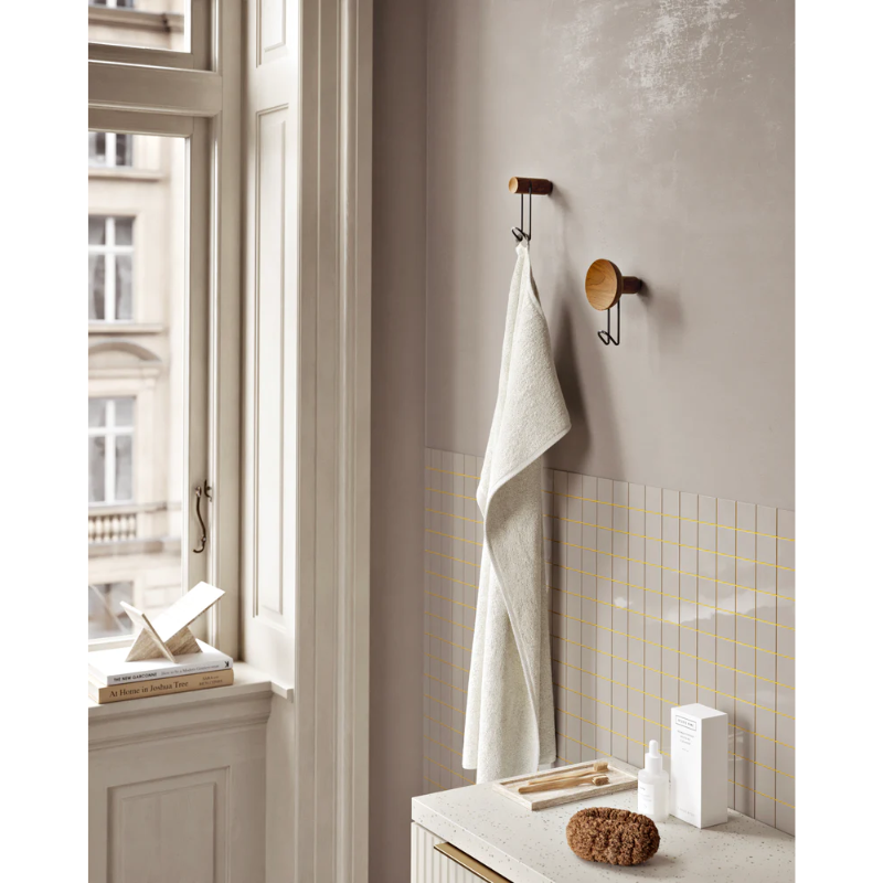 The Around Wall Hanger (Small) from Woud in a bathroom.