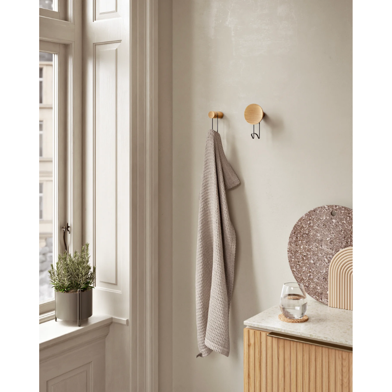 The Around Wall Hanger (Small) from Woud in a bedroom.