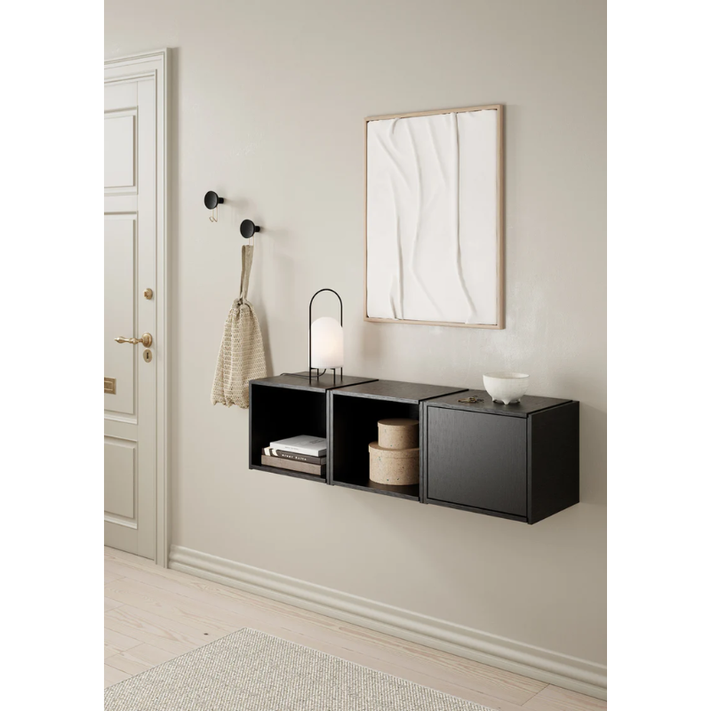 The Bricks Cube from Woud in black being used in a bathroom among other Woud products.