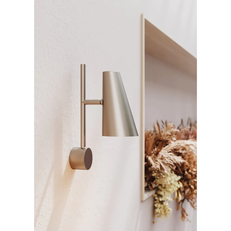 The Cono Wall Lamp from Woud in a living room.
