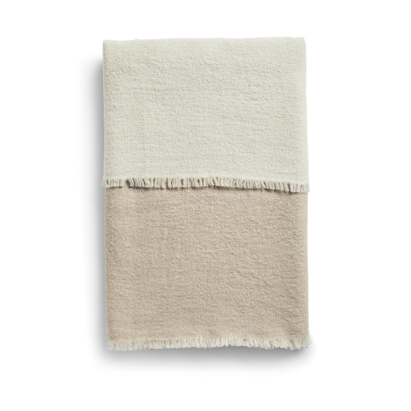 This is the Double Throw from Woud which is made out of 100% merino wool. The color pattern for this throw is beige and off white.