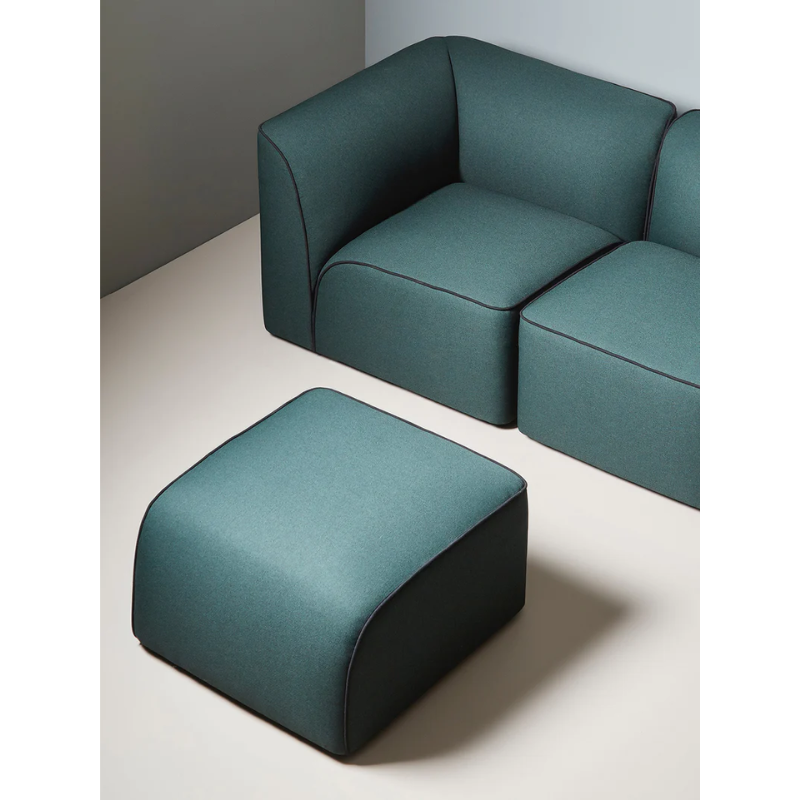 The Flora Pouf from Woud with a custom fabric in a lounge.