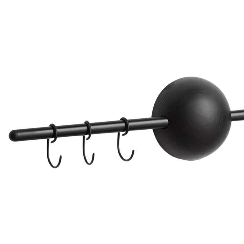 The Hoop Rack from Woud in black featured in a close up shot of the sphere and hooks of the rack.