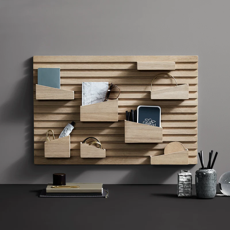 The Input Organizer from Woud being used in a lifestyle shot to organize multiple objects from glasses to notepads and pens.