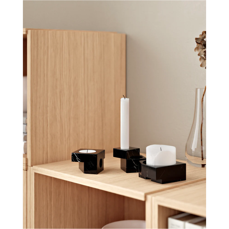 The solid marble Jeu De Dés 1 Candle Holder from Woud with the other candle holders in the design family.