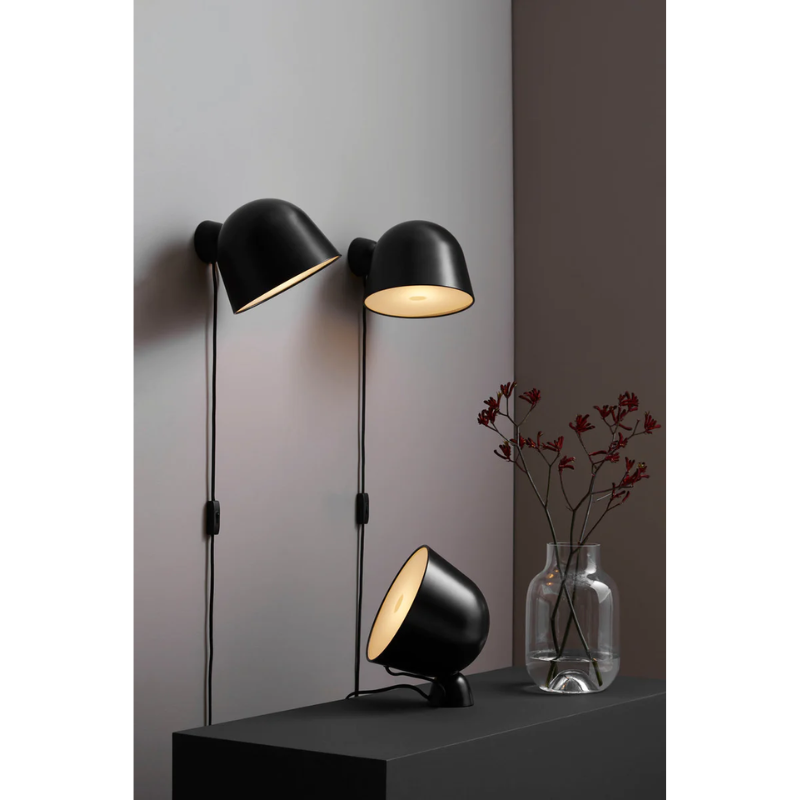 The Kuppi Wall Lamp 2.0 from Woud in a living room.