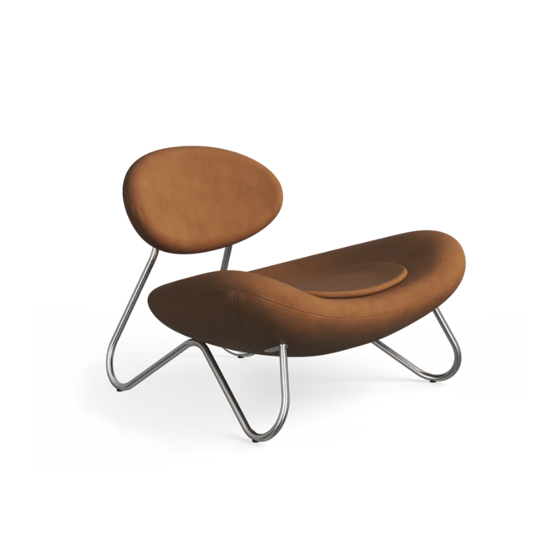 The Meadow Lounge Chair from Woud with cognac leather and brushed steel legs.