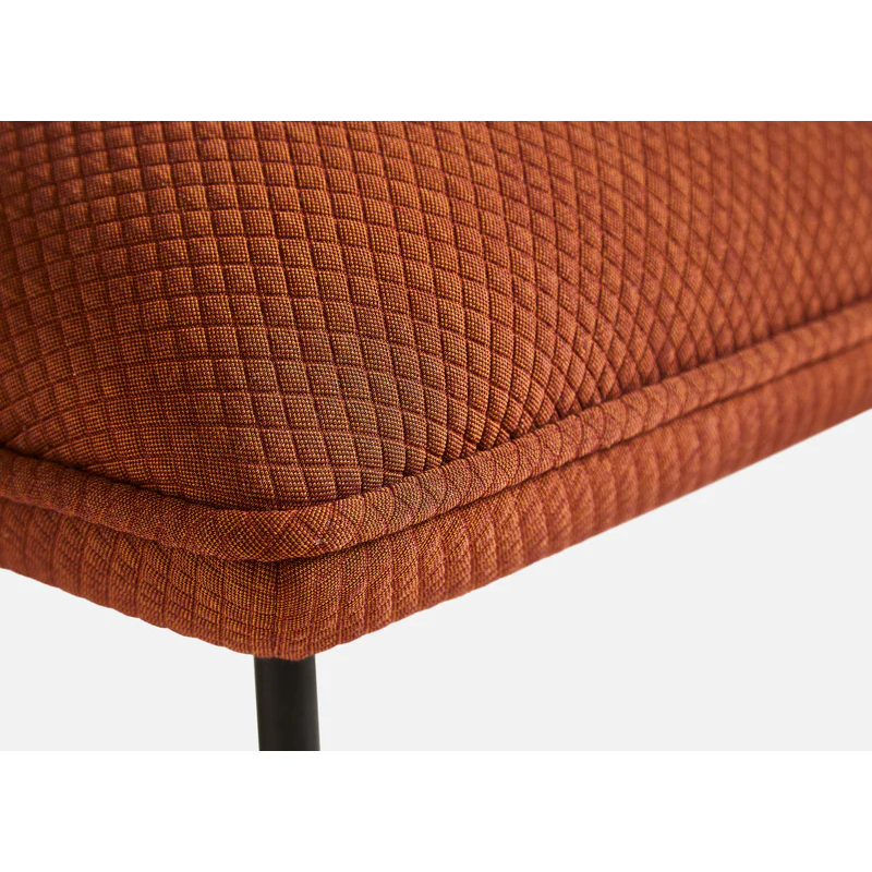The Nakki Lobby Ottoman from Woud with a custom fabric in a close up photograph.